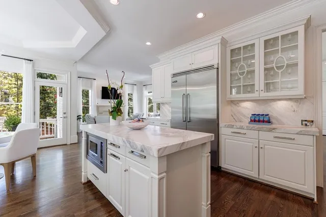 a bedroom with a balcony a bed and a chandelier