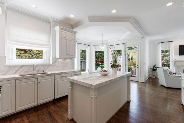 a bathroom with a granite countertop sink toilet a mirror and shower