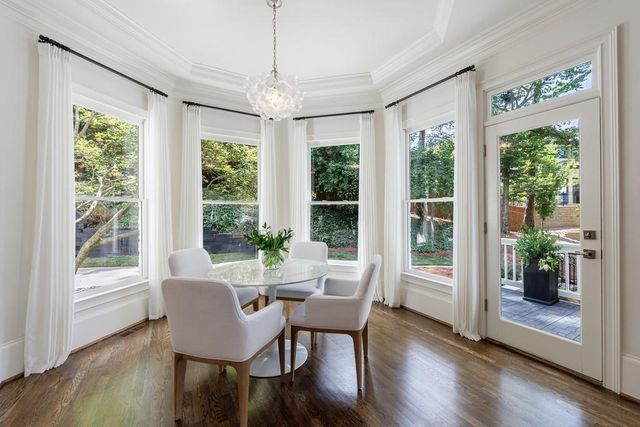 a spacious bedroom with a bed and wooden floor