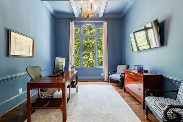 a room with a table chairs and wooden floor