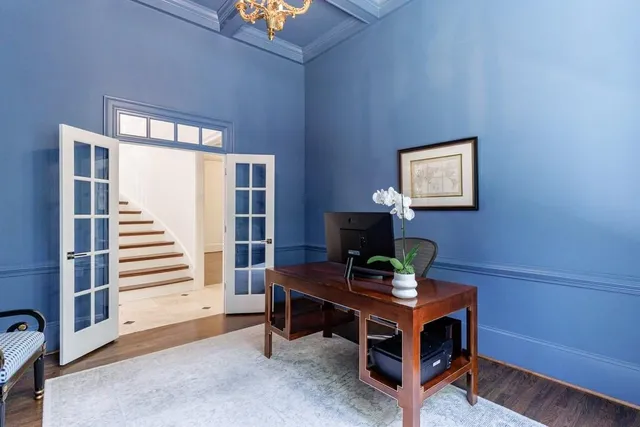 a kitchen with white cabinets and sink