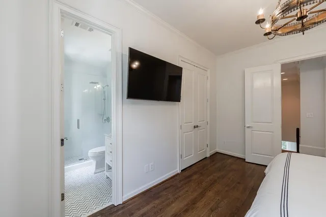 a bathroom with a granite countertop sink a toilet and shower