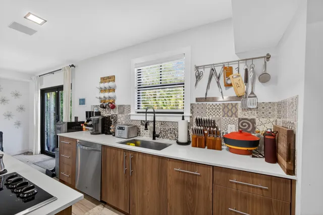 a kitchen with a sink cabinets and stainless steel appliances