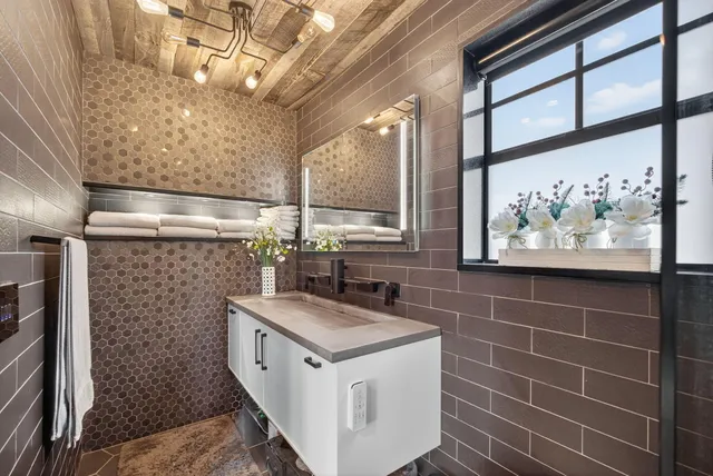 a bedroom with a bed and a ceiling fan