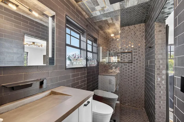 a bedroom with a bed and a ceiling fan