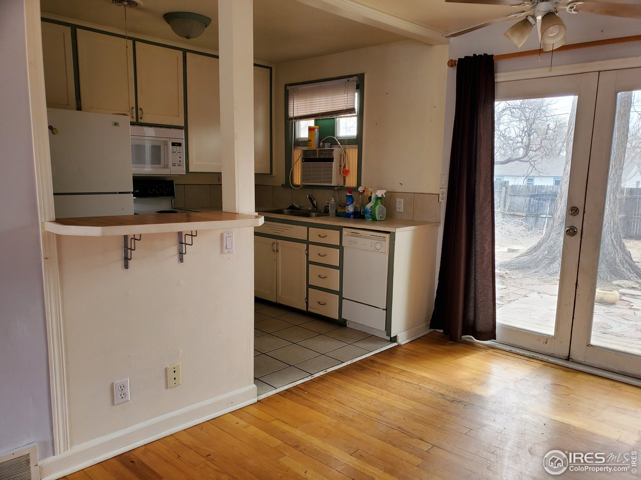 1026 23rd Street Road Greeley, CO 80631 - Photo 9 of 15 kitchen, dining, french door to backyard