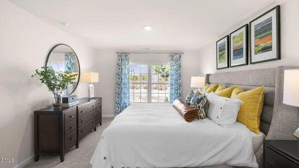 a spacious bedroom with a bed and a chandelier