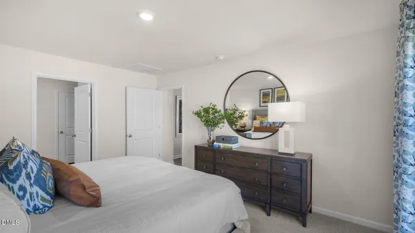 a bedroom with a bed and a dresser