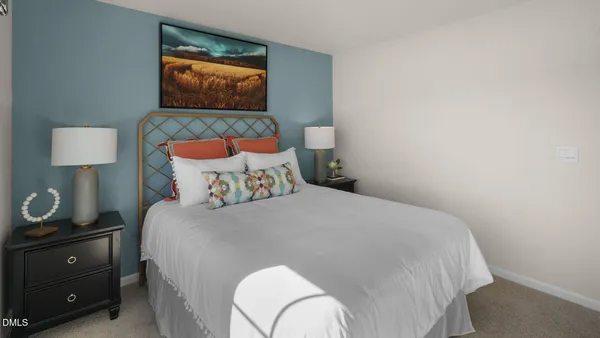 a bedroom with a bed and a lamp