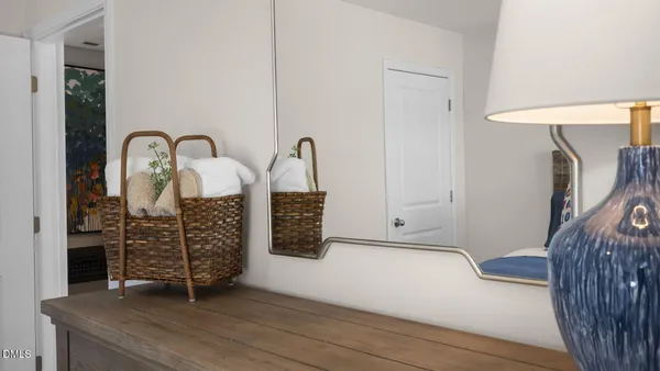 a view of an empty room with furniture and wooden floor