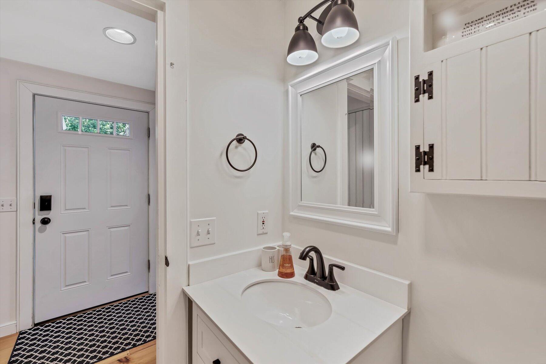 36 Brant Rock Road Mashpee, MA 02649 - Photo 11 of 23 a bathroom with a sink a mirror and a shower