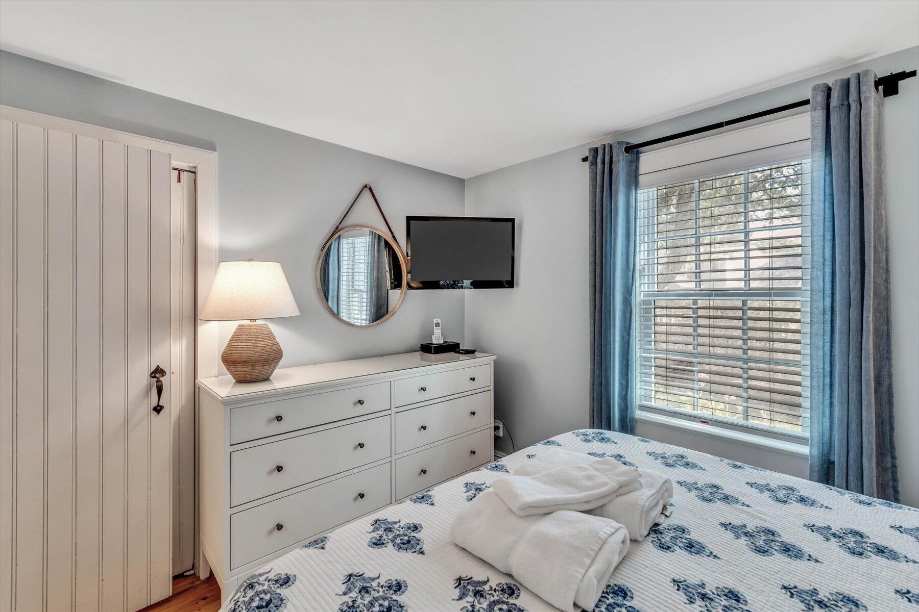 36 Brant Rock Road Mashpee, MA 02649 - Photo 13 of 23 a bedroom with a bed and a mirror on dresser