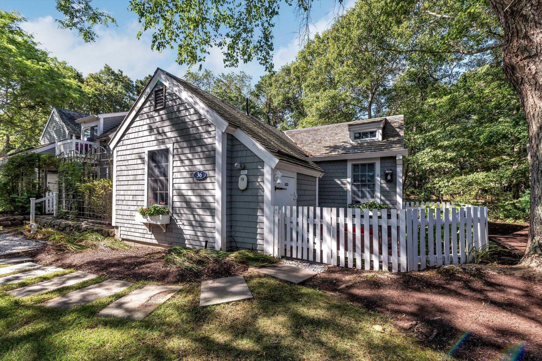 36 Brant Rock Road Mashpee, MA 02649 - Photo 2 of 23 a view of a house with a small yard and wooden fence