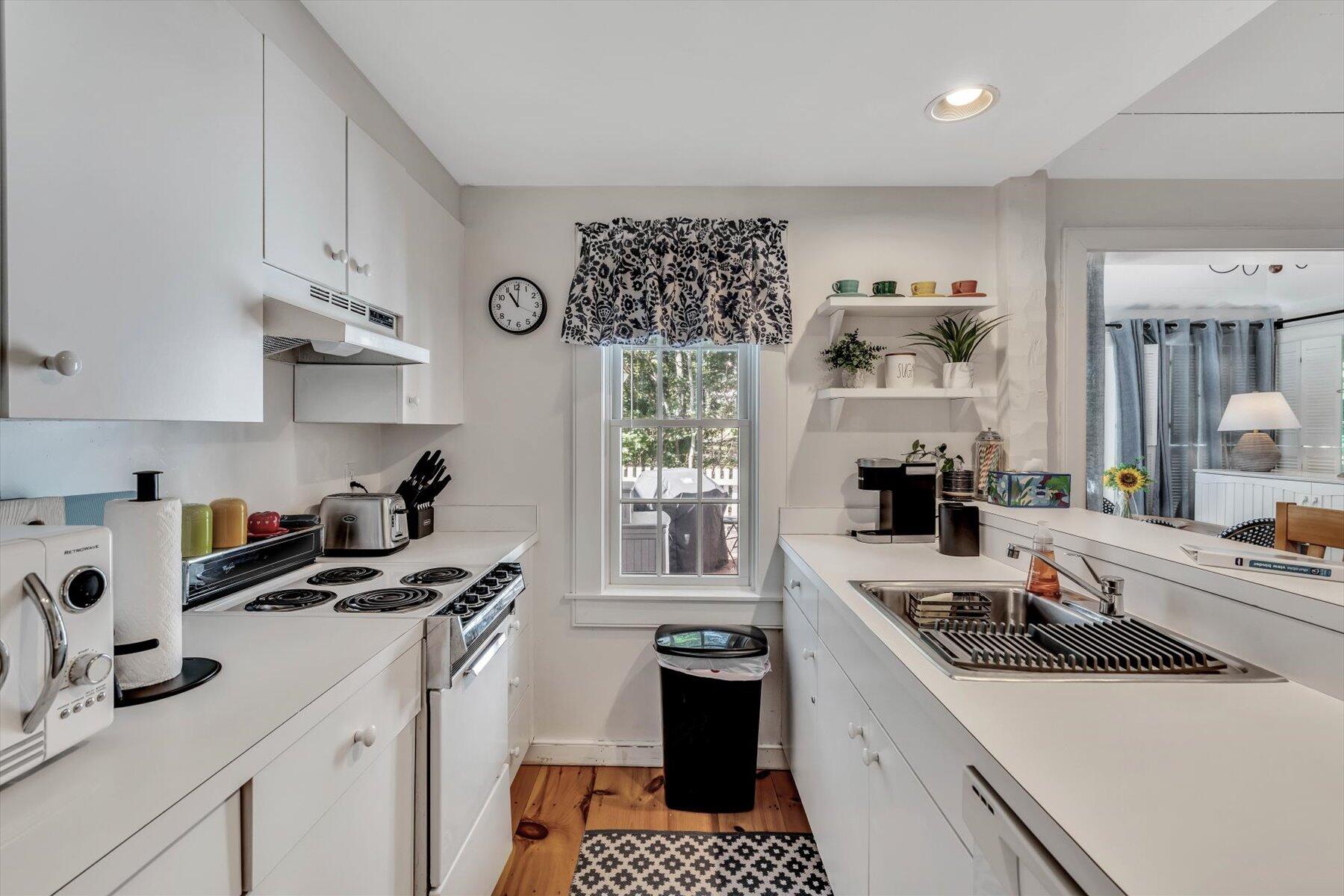 36 Brant Rock Road Mashpee, MA 02649 - Photo 8 of 23 a kitchen with a sink a stove and cabinets