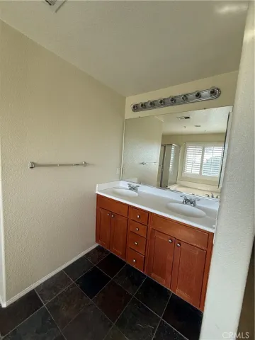 a bathroom with a double vanity sink and mirror