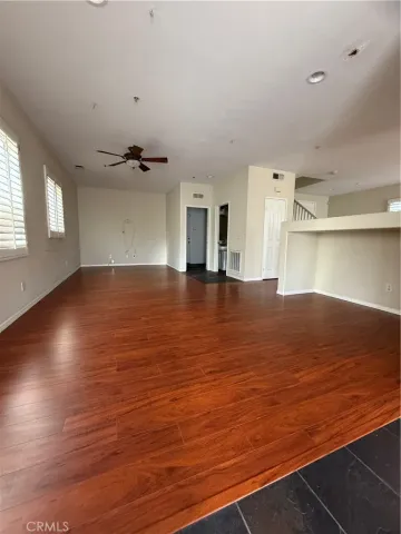 a view of a room with wooden floor