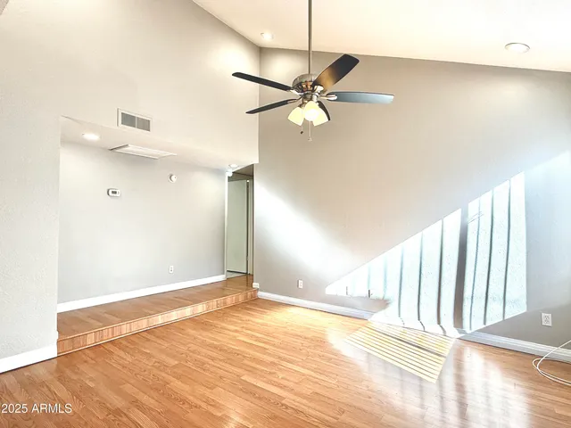 a view of a room with wooden floor