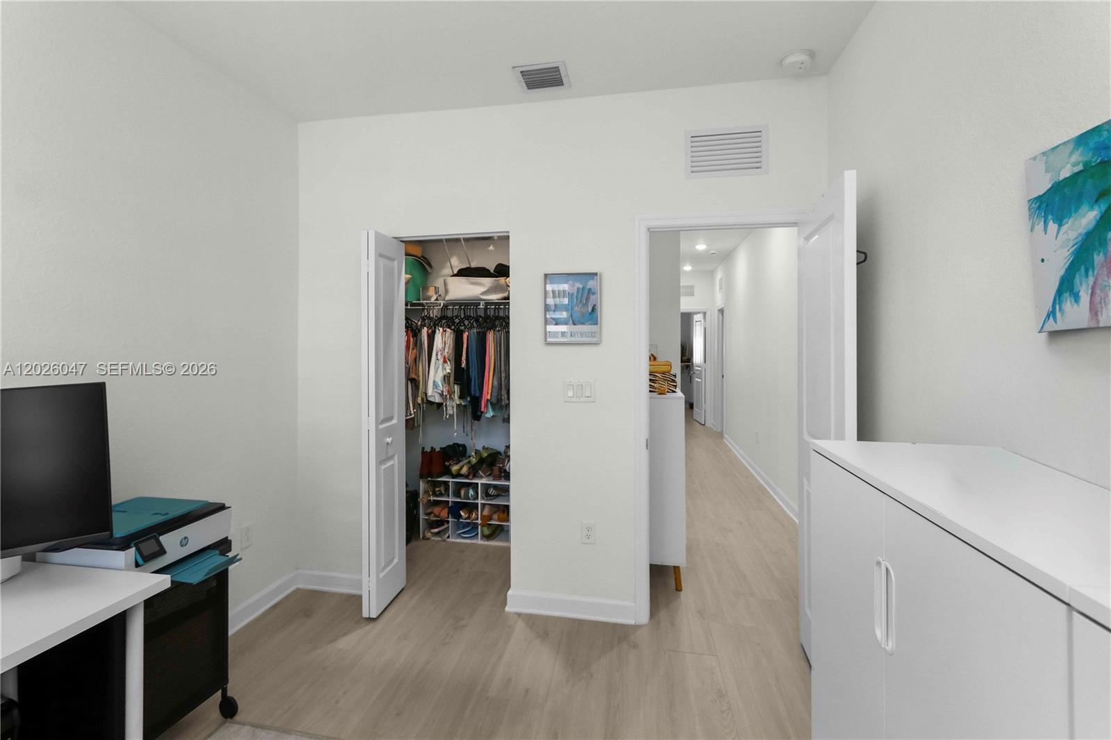 12862 Southwest 231st Street Miami, FL 33170 - Photo 19 of 30 a view of a workspace with furniture and wooden floor