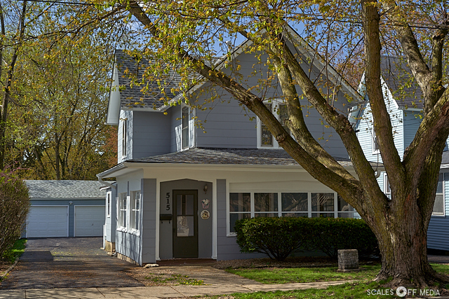 a view of a house with a tree in front of it