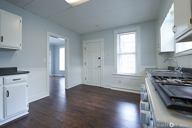 515 Walnut Avenue Elgin, IL 60123 - Photo 2 of 28 a kitchen with granite countertop a stove and a wooden floors