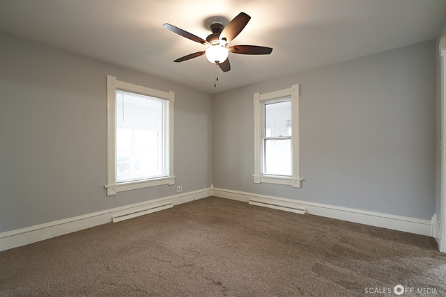 515 Walnut Avenue Elgin, IL 60123 - Photo 14 of 28 an empty room with a window and a ceiling fan