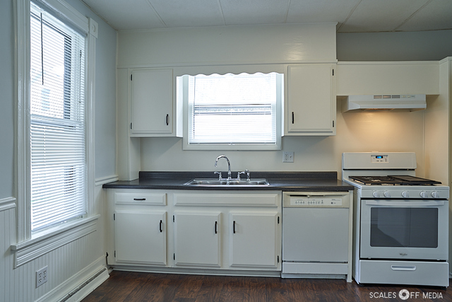 515 Walnut Avenue Elgin, IL 60123 - Photo 24 of 28 a kitchen with granite countertop white cabinets and white appliances
