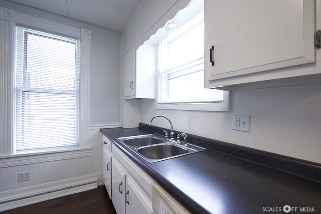 515 Walnut Avenue Elgin, IL 60123 - Photo 25 of 28 a kitchen that has a sink a window and cabinets