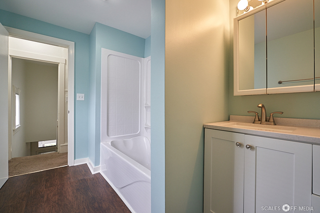 515 Walnut Avenue Elgin, IL 60123 - Photo 9 of 28 a bathroom with a sink and a mirror