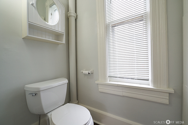 515 Walnut Avenue Elgin, IL 60123 - Photo 10 of 28 a white toilet sitting next to a window