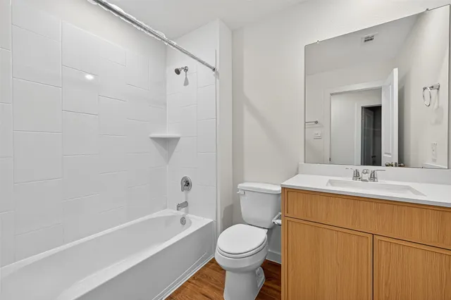 a white toilet sitting next to a white sink
