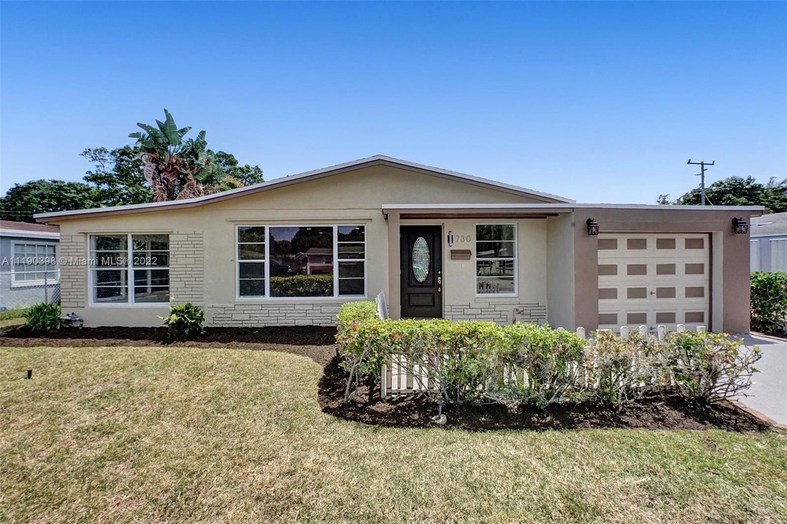 730 Northwest 18th Street Pompano Beach, FL 33060 - Photo 1 of 56 front view of a house with a garden