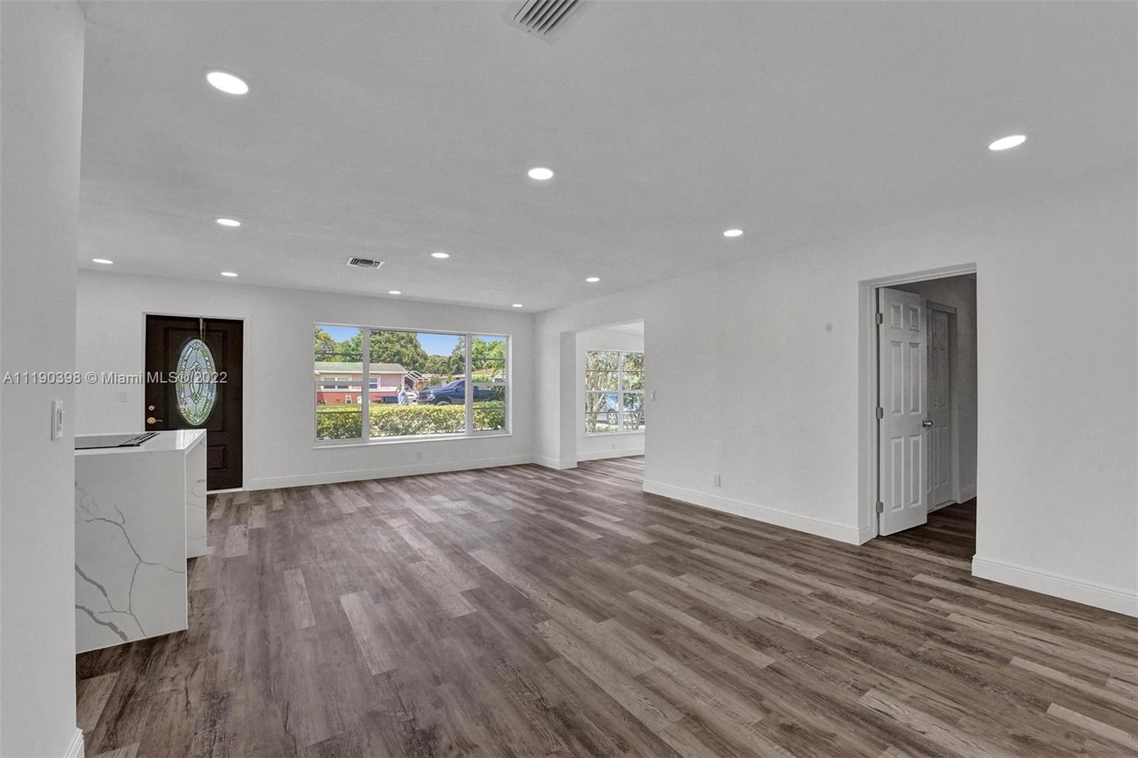 730 Northwest 18th Street Pompano Beach, FL 33060 - Photo 11 of 56 a view of an empty room with wooden floor and a window