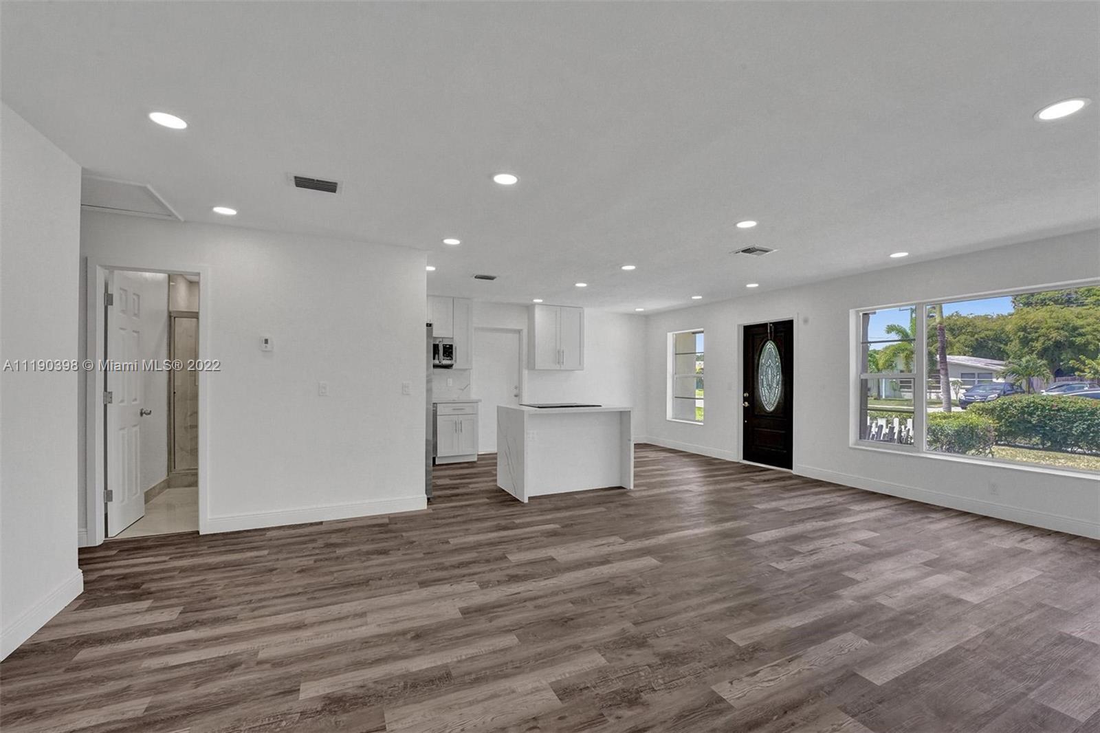 730 Northwest 18th Street Pompano Beach, FL 33060 - Photo 14 of 56 a view of an empty room with wooden floor and a window