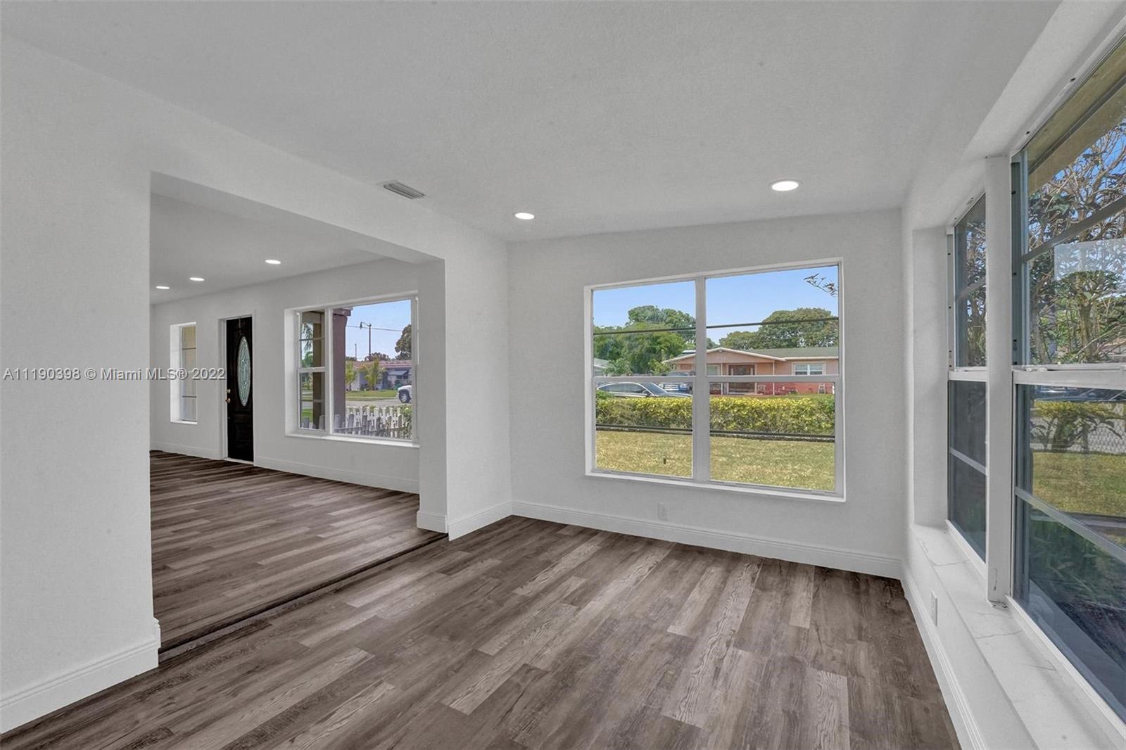 730 Northwest 18th Street Pompano Beach, FL 33060 - Photo 16 of 56 wooden floor in an empty room with a window