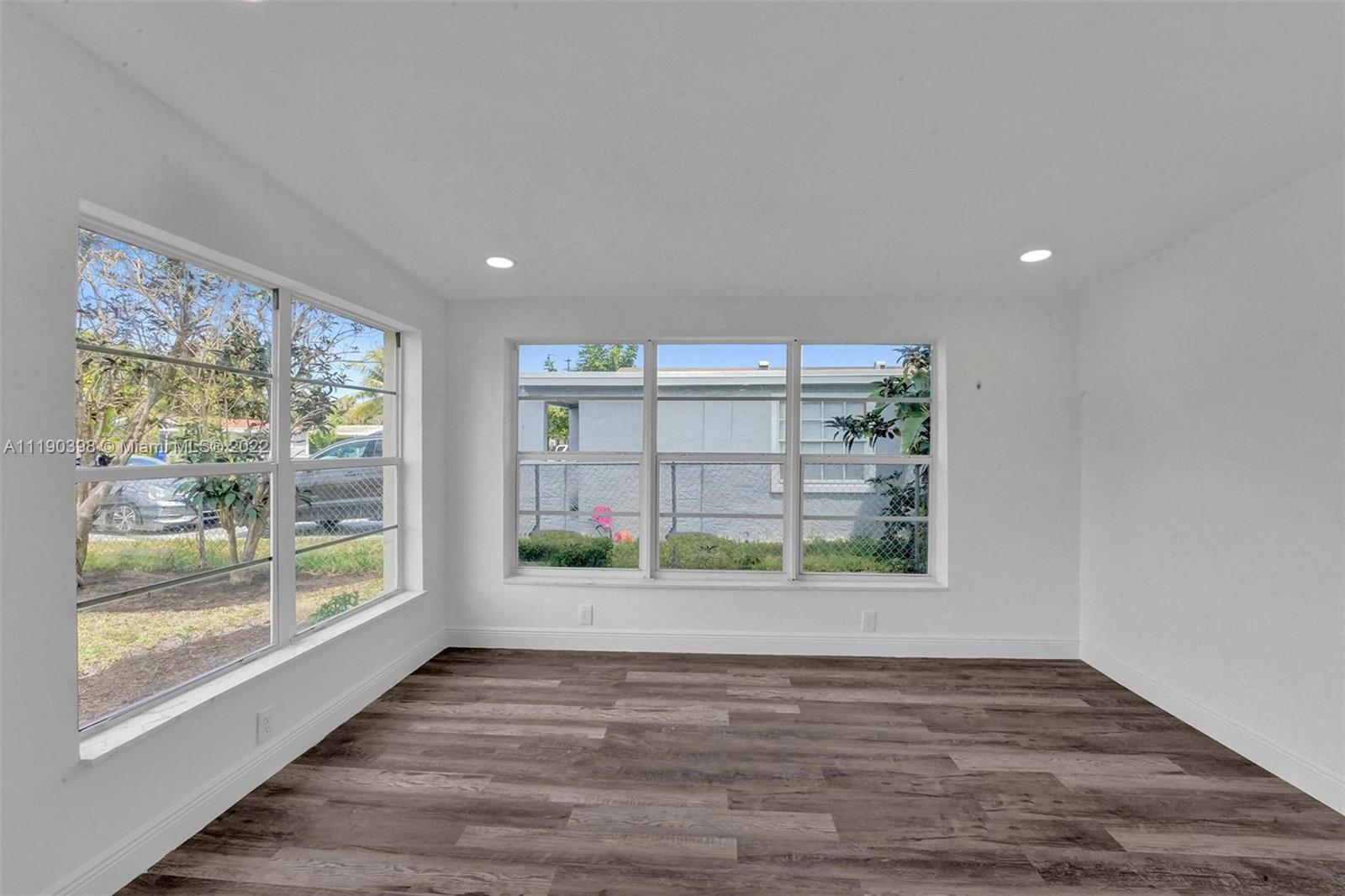 730 Northwest 18th Street Pompano Beach, FL 33060 - Photo 17 of 56 a view of an empty room with wooden floor and a window