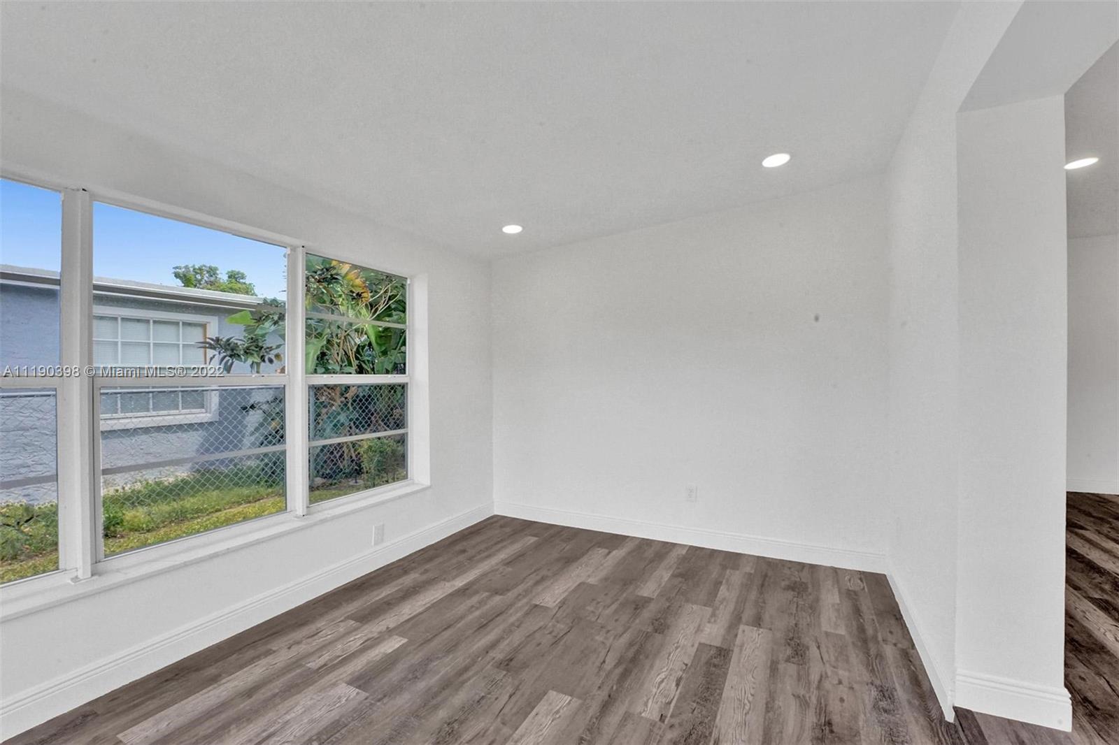 730 Northwest 18th Street Pompano Beach, FL 33060 - Photo 18 of 56 a view of empty room with wooden floor and fan
