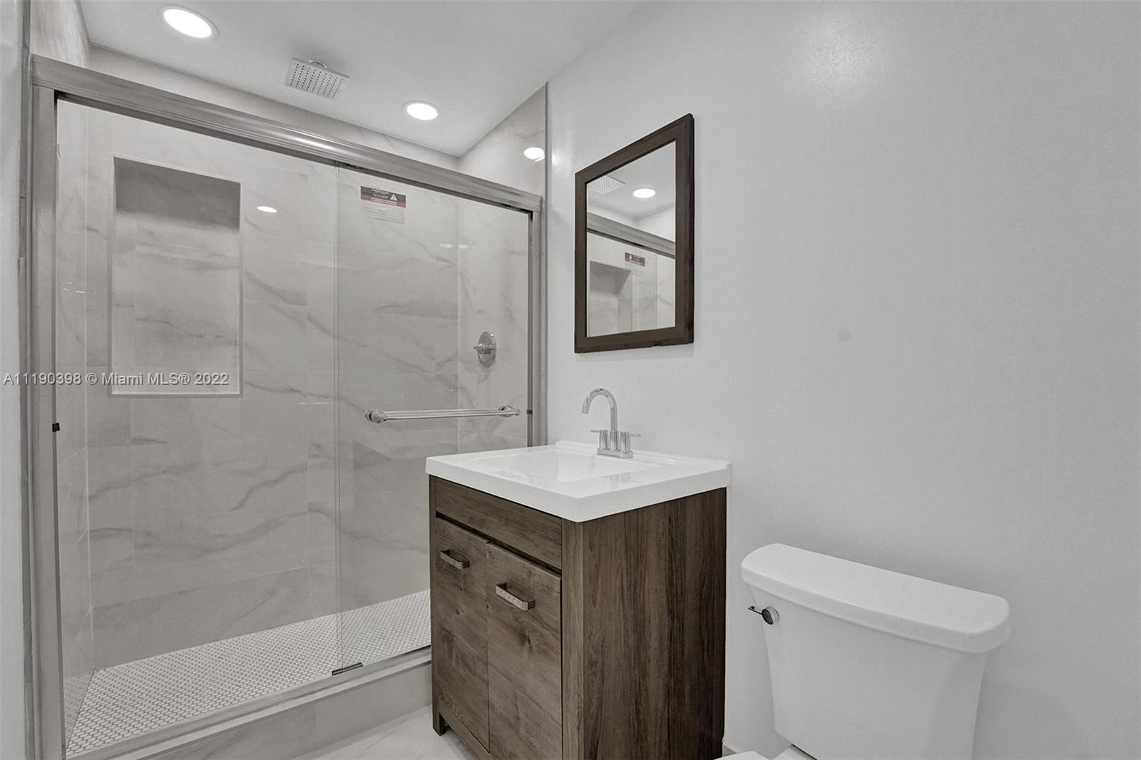 730 Northwest 18th Street Pompano Beach, FL 33060 - Photo 19 of 56 a bathroom with a sink a toilet and shower