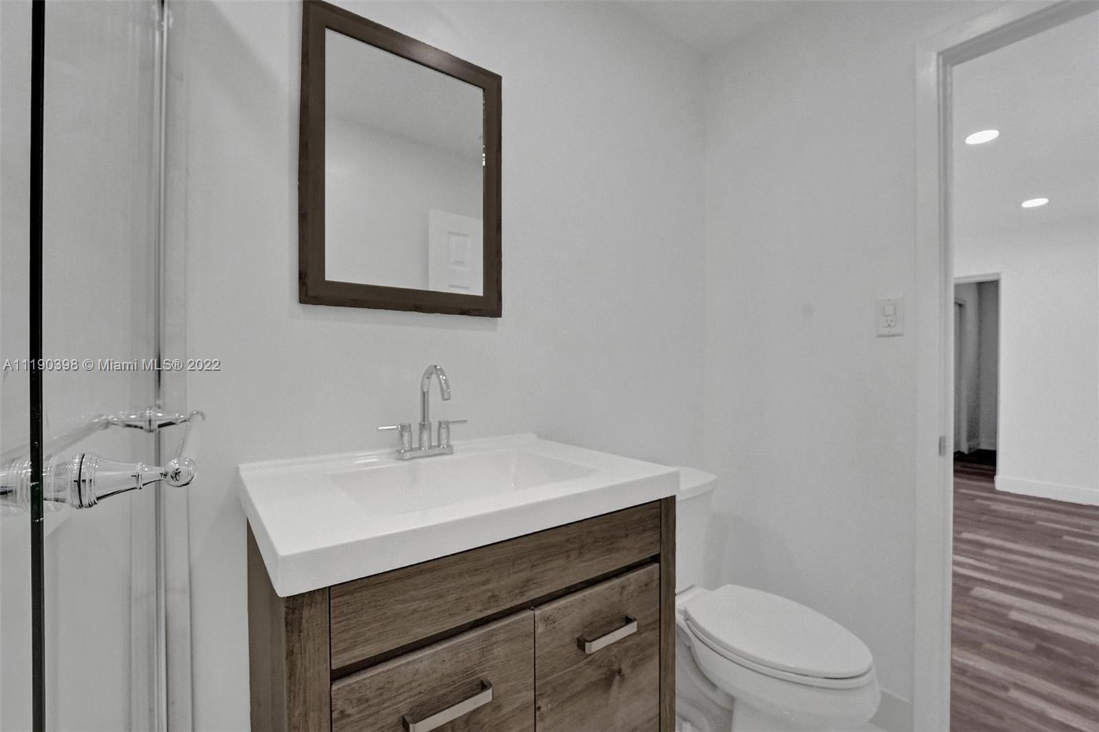 730 Northwest 18th Street Pompano Beach, FL 33060 - Photo 20 of 56 a bathroom with a sink toilet and mirror