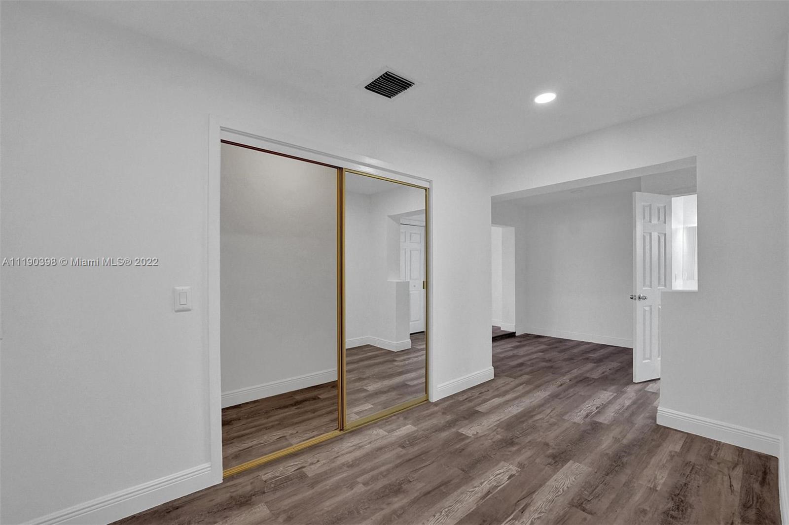 730 Northwest 18th Street Pompano Beach, FL 33060 - Photo 21 of 56 a view of an empty room with wooden floor