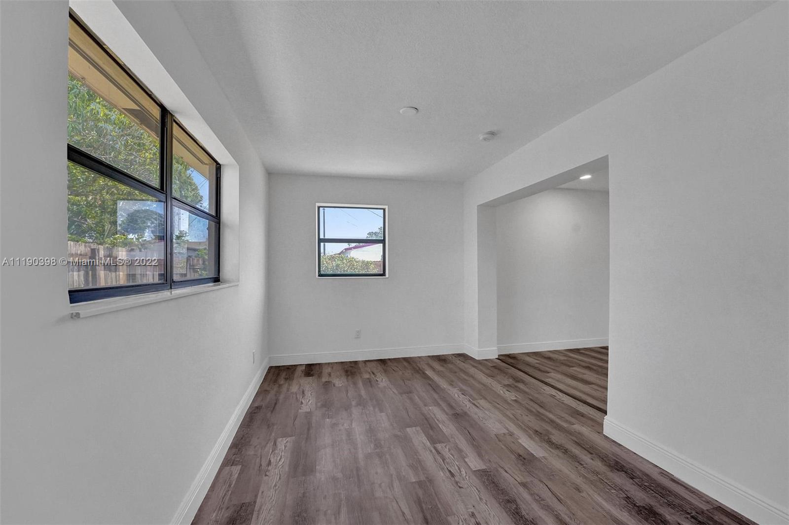 730 Northwest 18th Street Pompano Beach, FL 33060 - Photo 27 of 56 a view of empty room with wooden floor and fan