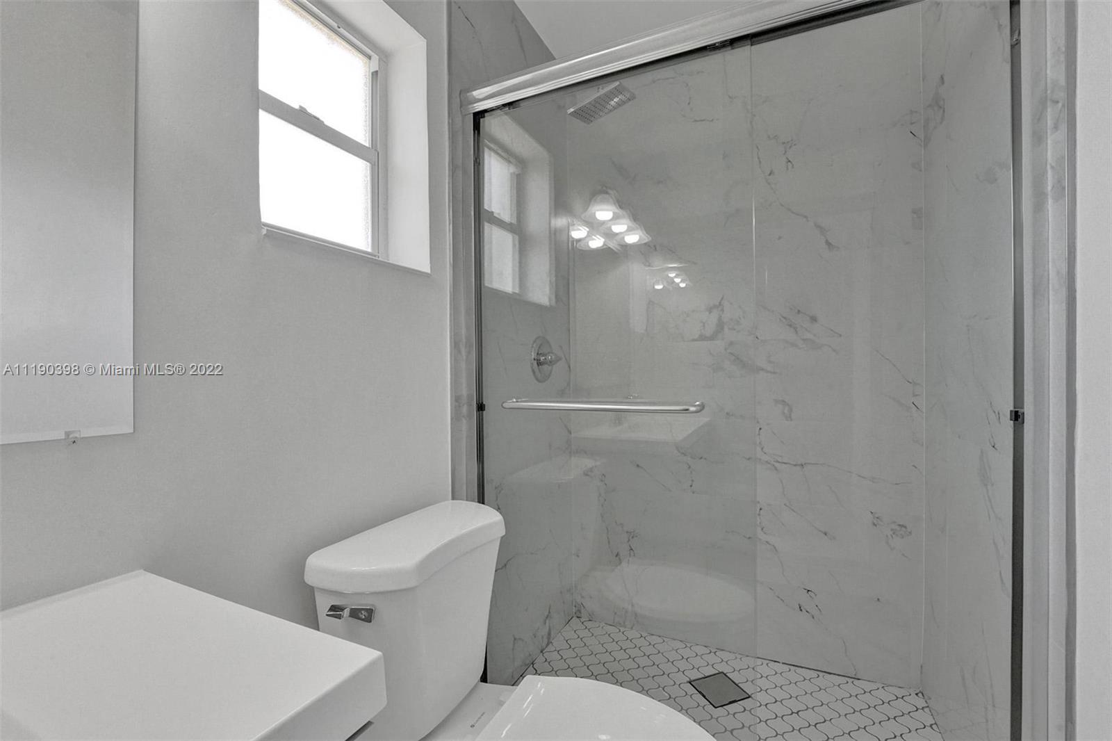 730 Northwest 18th Street Pompano Beach, FL 33060 - Photo 31 of 56 a bathroom with a shower and a toilet