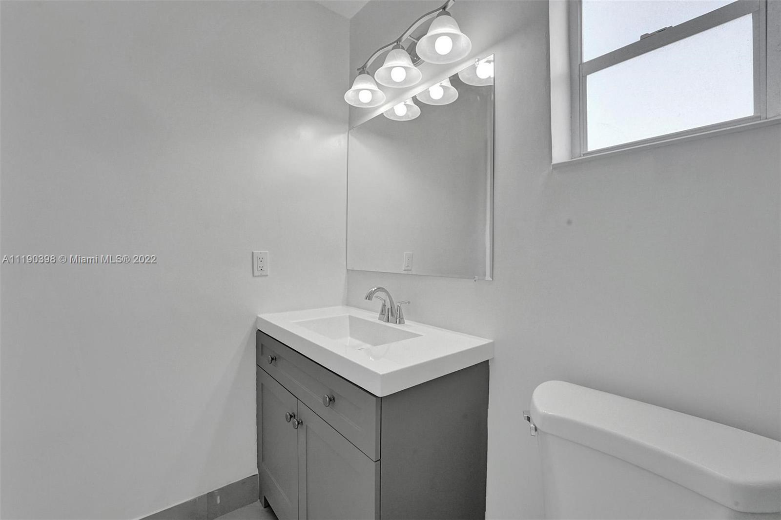 730 Northwest 18th Street Pompano Beach, FL 33060 - Photo 32 of 56 a bathroom with a sink and a mirror