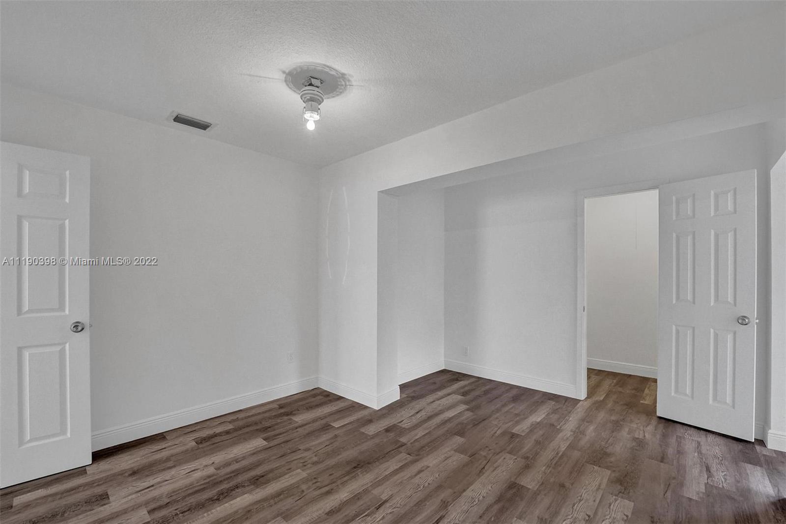 730 Northwest 18th Street Pompano Beach, FL 33060 - Photo 34 of 56 a view of empty room with wooden floor