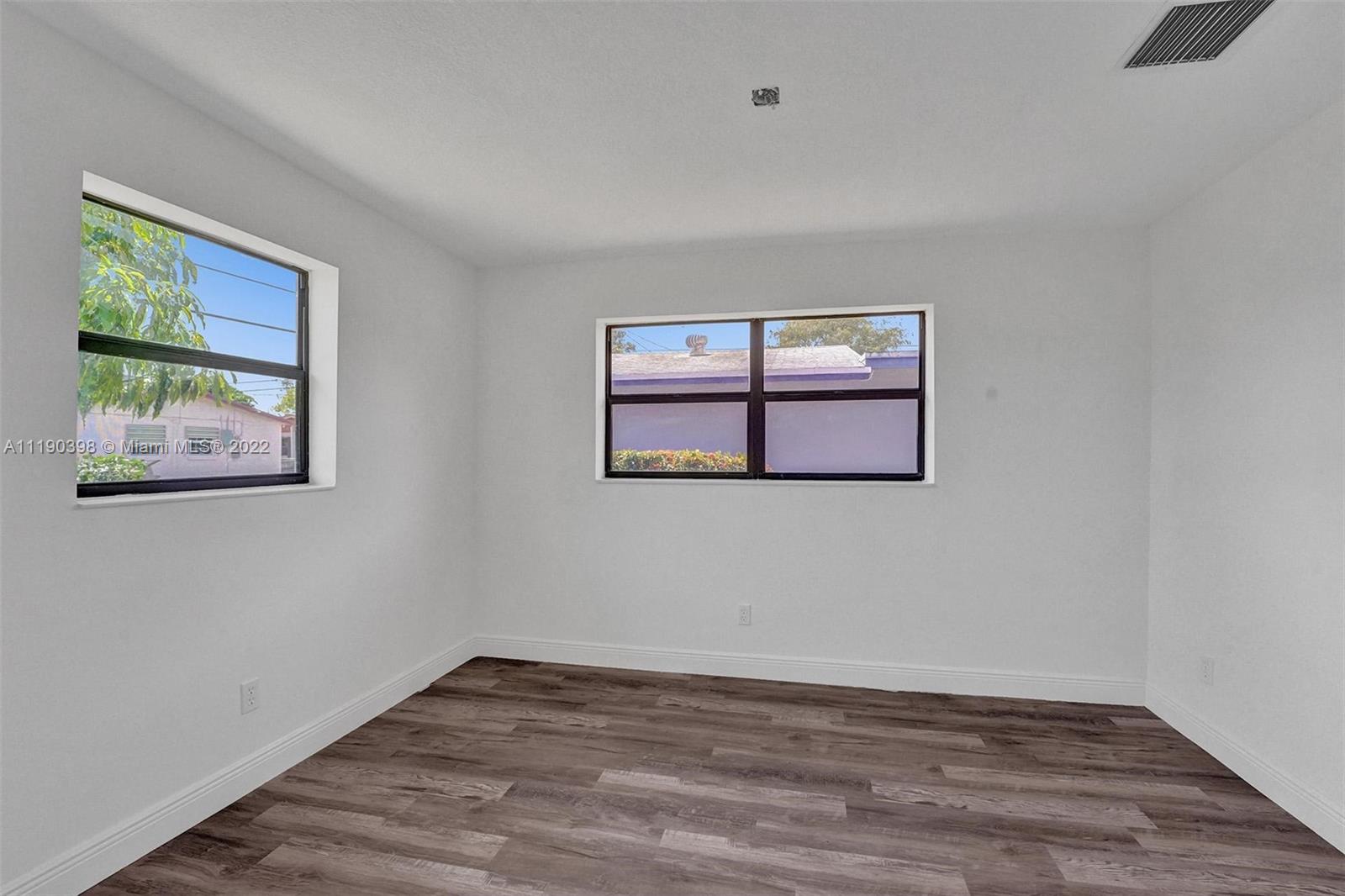 730 Northwest 18th Street Pompano Beach, FL 33060 - Photo 37 of 56 a view of a room with wooden floor and window