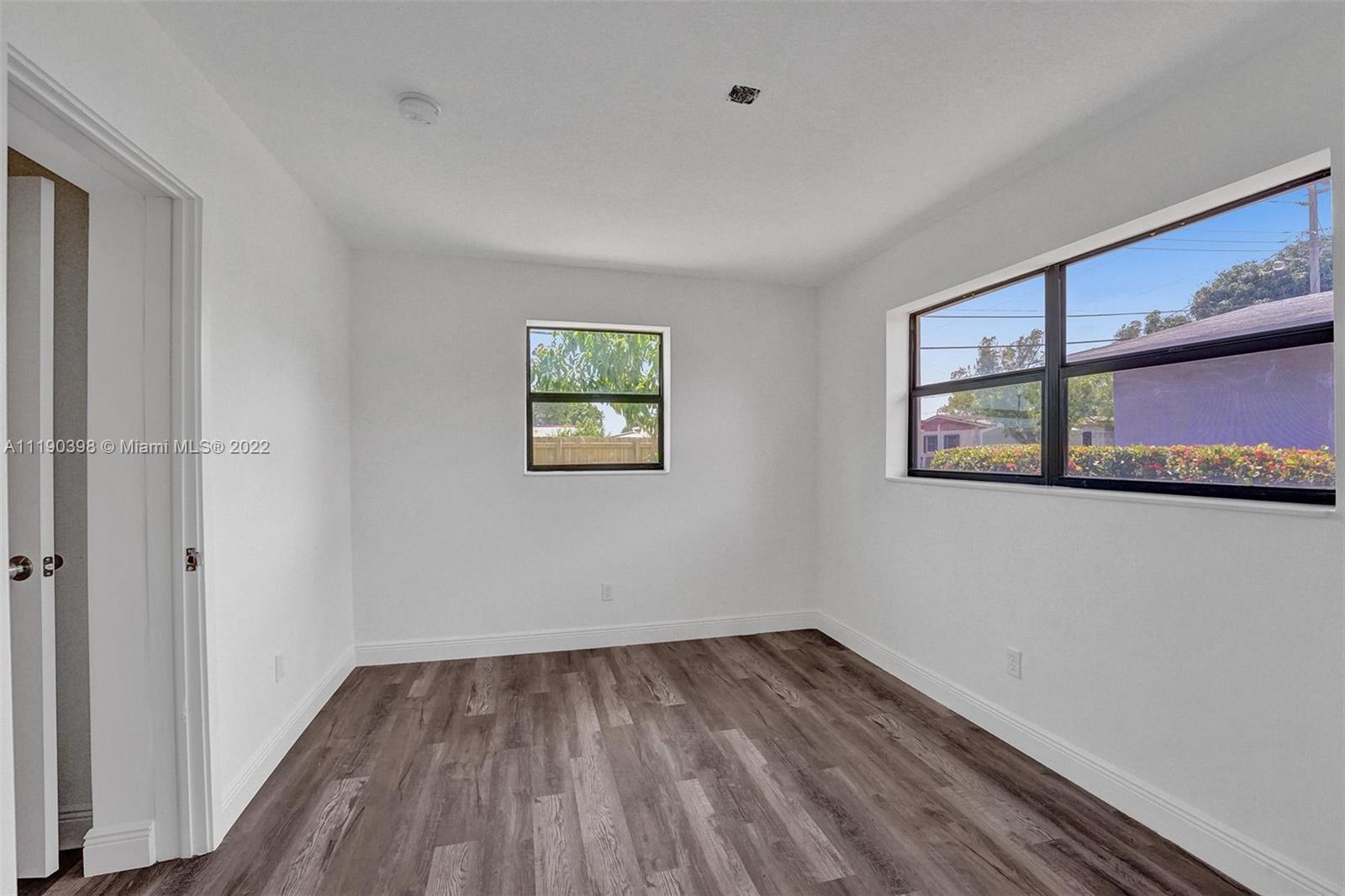 730 Northwest 18th Street Pompano Beach, FL 33060 - Photo 38 of 56 a view of empty room with wooden floor and fan