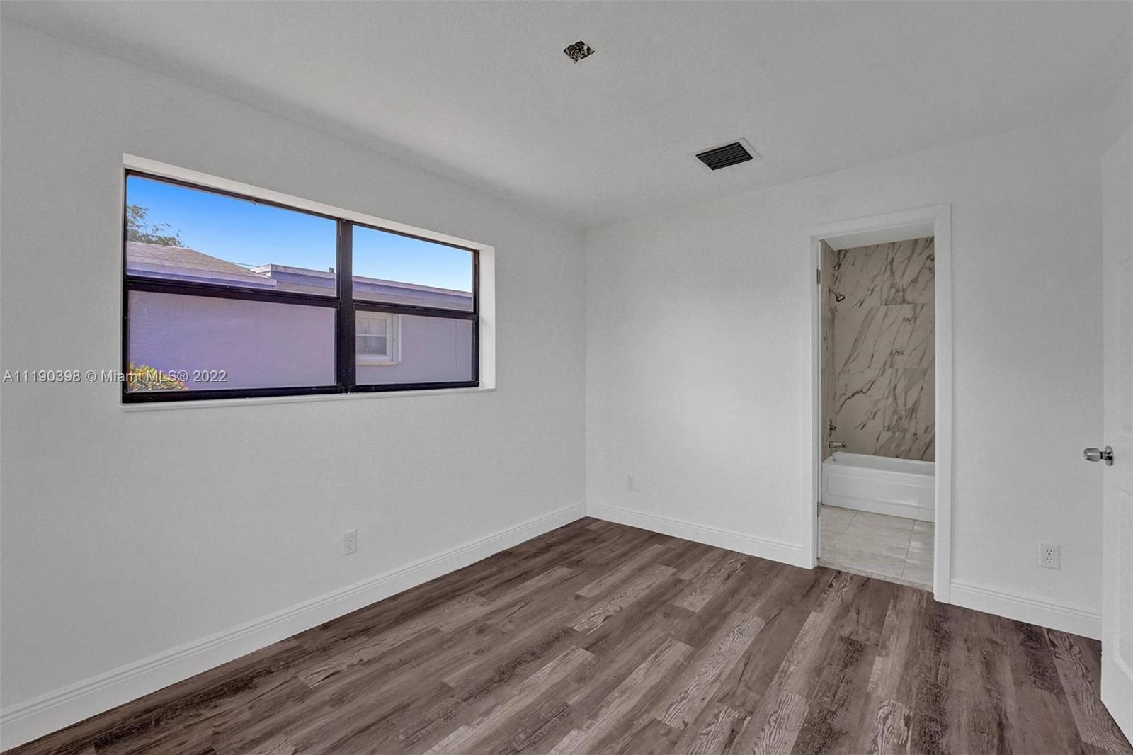 730 Northwest 18th Street Pompano Beach, FL 33060 - Photo 39 of 56 a view of a room with wooden floor and window