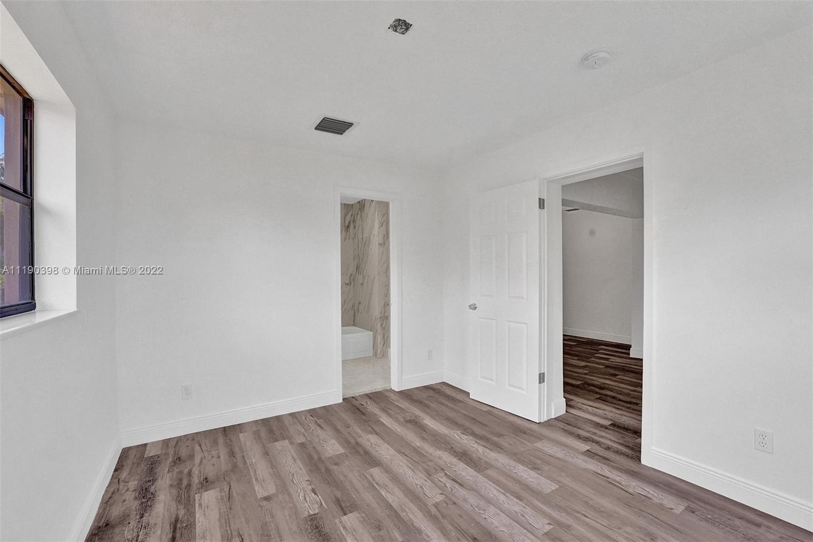 730 Northwest 18th Street Pompano Beach, FL 33060 - Photo 40 of 56 a view of a room with wooden floor and hallway