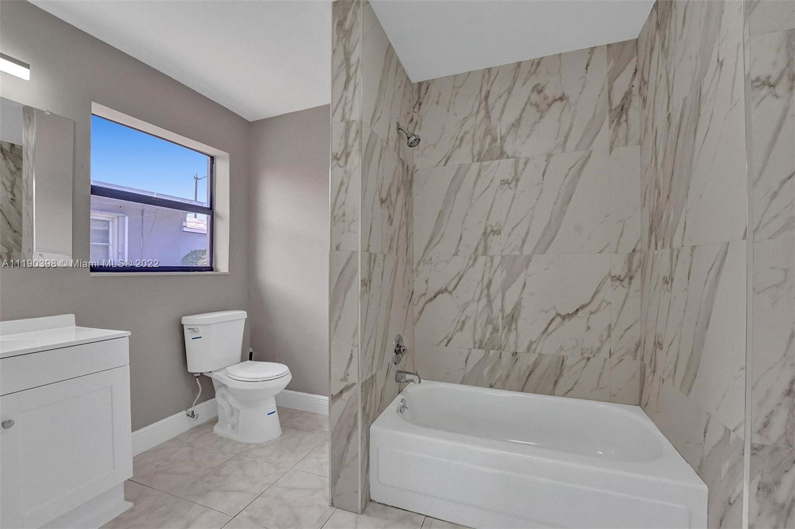 730 Northwest 18th Street Pompano Beach, FL 33060 - Photo 41 of 56 a bathroom with a toilet a sink and bathtub