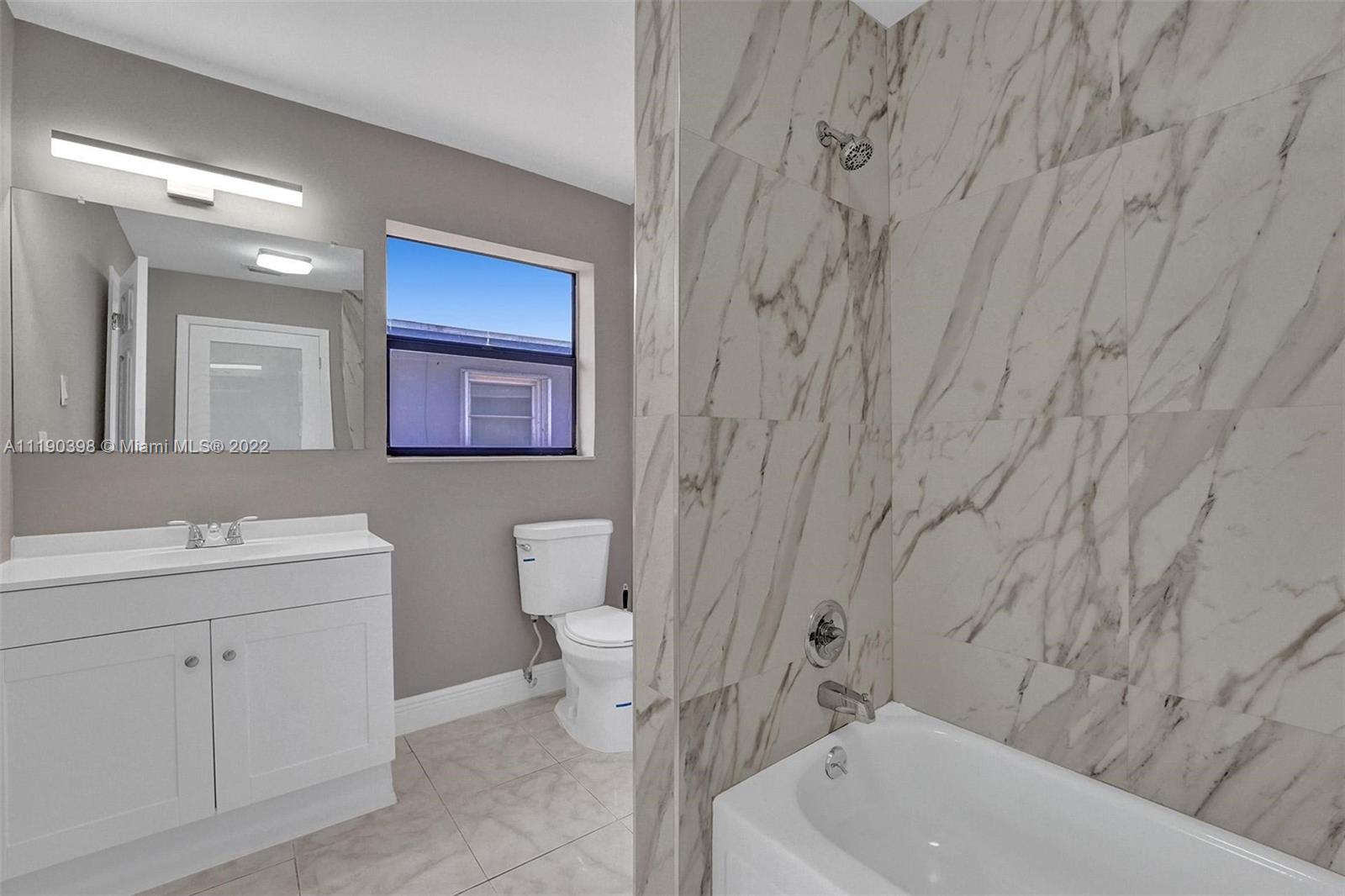 730 Northwest 18th Street Pompano Beach, FL 33060 - Photo 42 of 56 a bathroom with a sink a toilet and shower