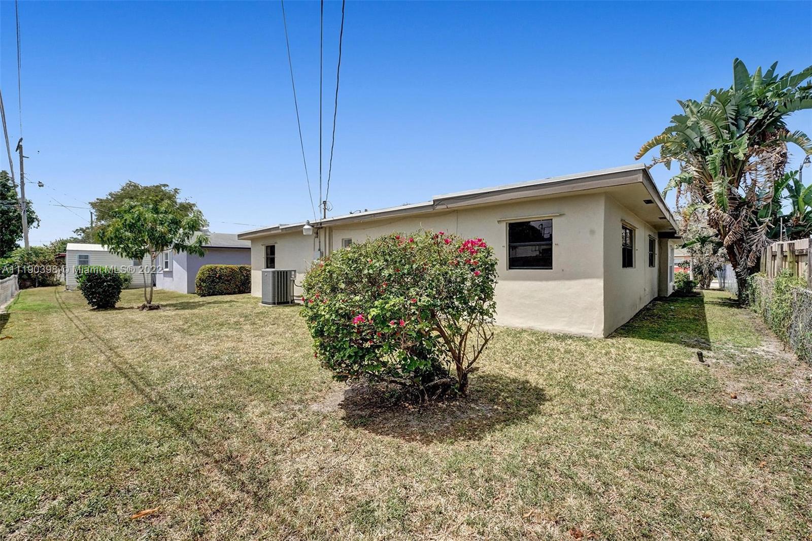 730 Northwest 18th Street Pompano Beach, FL 33060 - Photo 56 of 56 a front view of a house with garden